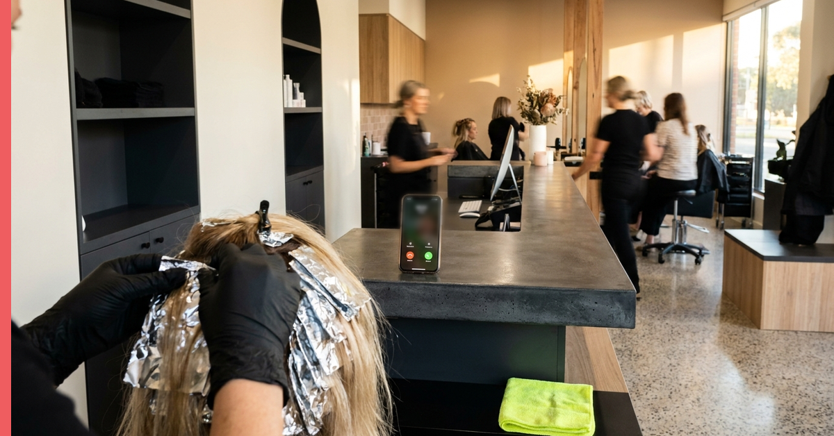 Salon stylist mid-foil while the booking phone rings out on the counter