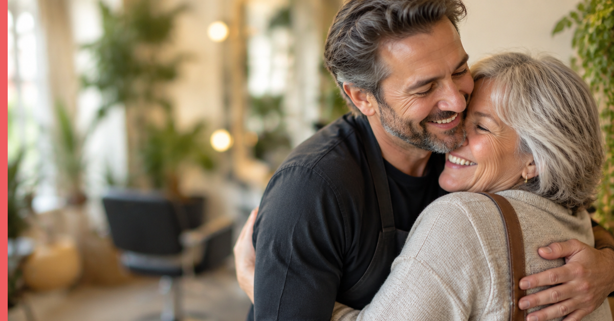 Hairdresser hugging a long-time client hello, a picture of salon client ownership built on real relationships